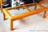 Hardwood and glass coffee table is in good condition and matches lot #316 and #314. Measures 51