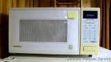 Gold Star microwave with one touch controls for popcorn, pizza, vegetables. Works. Handy smaller