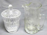 Blown glass pitcher with applied handle and etched floral design. Leaded glass covered dish. No