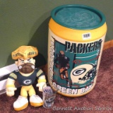Green Bay Packers garbage can, stuffed cheesehead figure, shot glass and beer glass. Garbage can
