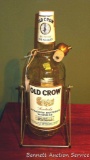 Huge Old Crow Whiskey bottle in tipping stand. Measures 20