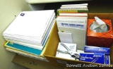 Tons of scratch paper and note pads as pictured, plus some paperclips and a hole punch.