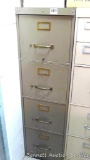Nice sturdy four drawer file cabinet is in good condition and measures 52