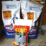One full and one partial bag of Kingsford charcoal; unopened bag of ice melt.