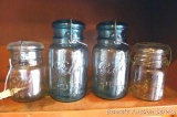 Two blue quart bale top Ball Ideal jars; one pint Ball Ideal bale top jar; one other bale top jar.