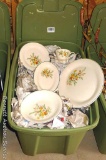 Tote full of floral pattern dishes by Edwin Knowles Co. Lots of pieces are wrapped carefully.