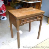 Vintage sewing machine table is a great side table. Machine is not included. Cabinet has some water
