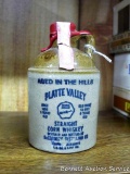 Sealed 1/2 pint stoneware jug of Platte Valley McCormick straight corn whiskey, wax sealed with tax