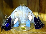 Pretty stained glass Nativity set includes manger backdrop, Mary and Joseph, baby Jesus, two angels.
