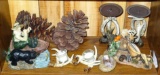 Northwoods themed nick nacks include a couple of pinecones, four antler look candle holders,