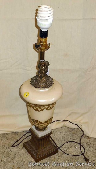 Lovely antique lamp with embossed design. Approx. 28" high. Harp is missing. Worked when tested.