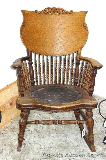 Beautiful antique rocker with scroll design on back. Approx. 23" w x 35" h. In nice condition.