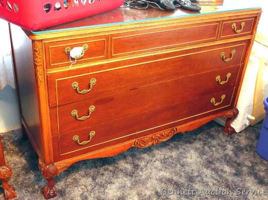 Antique four drawer dresser with scroll accents, claw feet and decorative hardware. Approx. 51" w x