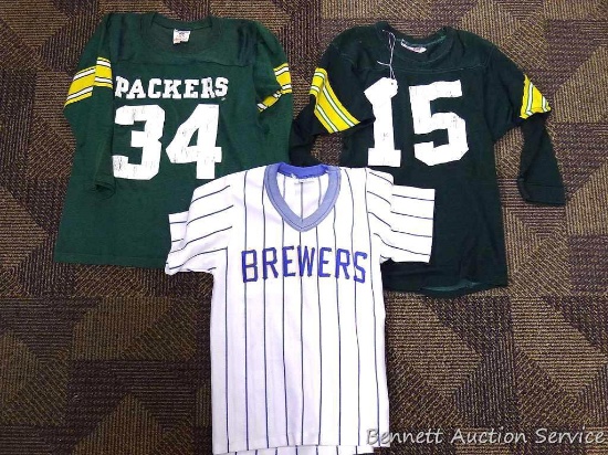 Green Bay Packers shirts size Youth S, and M; Milwaukee Brewers shirt, Youth M. All shirts are worn.