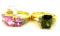 Two rings. Seller's description states 'olive green peridot ring, size 9; oval pink sapphire ring,