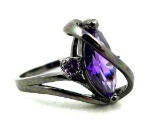 Seller's description states 'purple amethyst 'S' shaped black gold filled ring, size 8'.