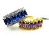 Two rings. Seller's description states 'blue sapphire band, size 6; purple amethyst ring, size 6'.