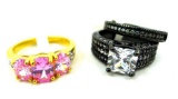 Two rings. Seller's description states 'princess cut white topaz black gold engagement set, size 9;