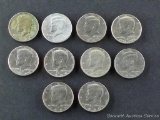 Ten mixed date Kennedy half dollars.