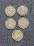 One Kennedy and four Franklin half dollars (all silver)