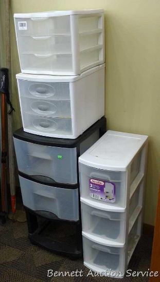 Three Sterlite storage containers with drawers and one other unit. Largest Sterlite has three