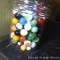 Pint jar nearly full of delightful old glass marbles.