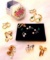 Eight pair of clip or screw post style earrings, plus a few pair of faux pearls and sparkly green