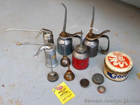 Assortment of oil cans from 5" to 10" tall; and vintage can of Goop hand cleaner.