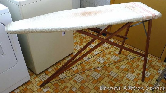 Solid wood vintage ironing board is in very good shape and stands 5' tall. Cloth cover shows some
