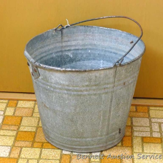 Galvanized bucket stands 10" tall. No pinholes noted.