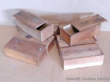 Eight wooden boxes with sliding tops, each a little over 7