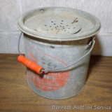 Old galvanized bait bucket with original wooden handle cost $2.69 in its day. Nice display piece.