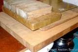 Four solid wood cutting boards or chopping blocks; plus one glass cutting board. Largest wooden