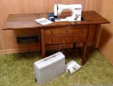 Necchi Lydia3 sewing machine in cabinet includes cover. Front of wooden cabinet opens to store oils,