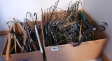 Two boxes of clothes hangers including some nice wooden hangers.