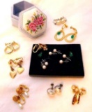 Eight pair of clip or screw post style earrings, plus a few pair of faux pearls and sparkly green