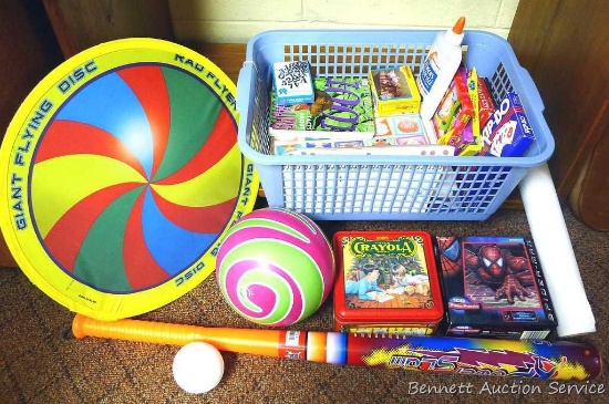 Basket of children's games and more. Bat and ball set, flying disc, card games, crayons and more. If