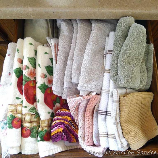 Assorted kitchen towels, dishcloths, homemade dishcloths and placemats.