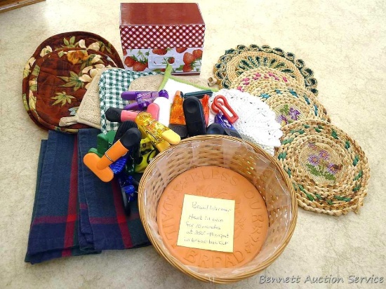 Assortment of potholders, trivets, bread basket with bread warmer, recipe box and magnetic clips.