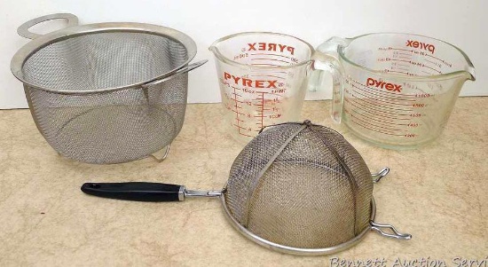 Pyrex 2 cup and 4 cup glass measuring pitchers, strainer and another wire basket. All in nice