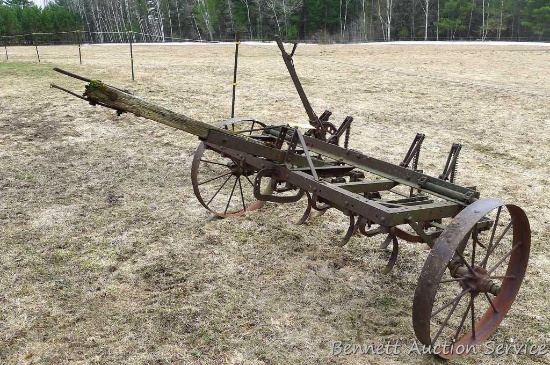 Old horse drawn cultivator will look great in your yard. Approx. 7' wide and 8-1/2' long. Believed
