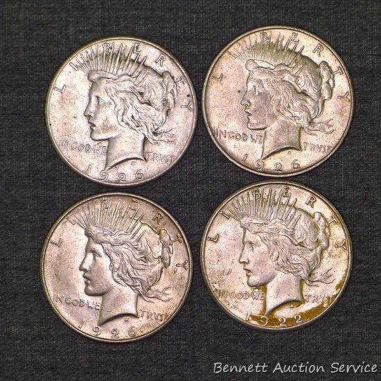 Four silver Peace dollars including 1922-S, 1926-S, 1926-D, 1926-D.