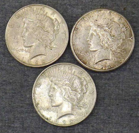 Three silver Peace dollars including 1922, 1922-S, 1922-D.