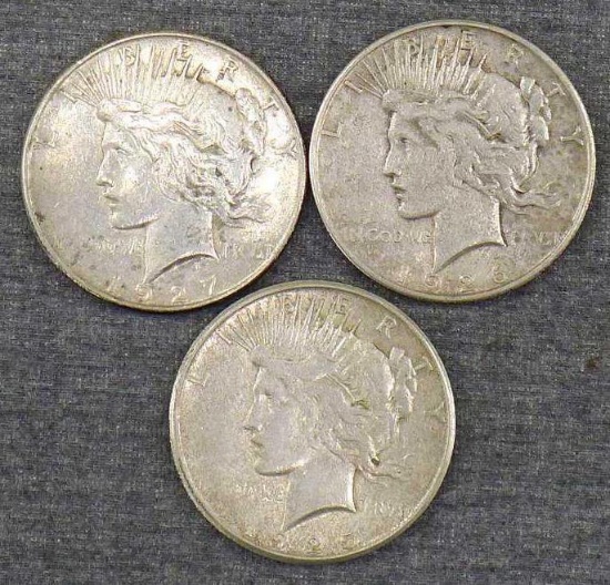 Three silver Peace dollars including 1925-S, 1926-S, 1927-S.