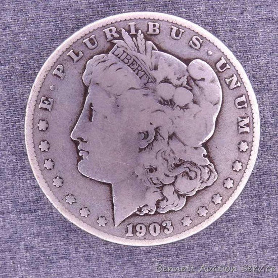 1903-S Morgan silver dollar. Pleasant coin with uniform wear and two old worn dings in the rim above
