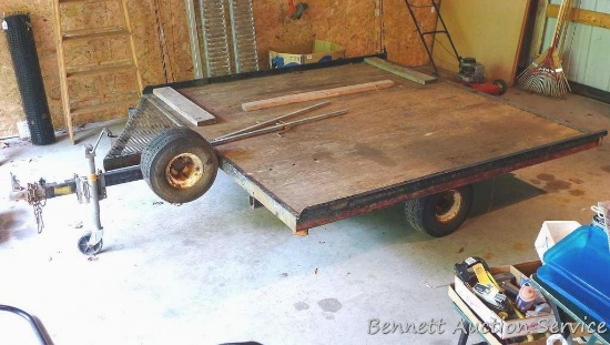 Double wide steel snowmobile trailer, 8' x 8'. Includes metal loading ramp and ski hold downs. Tire