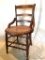 Parlor Chair: Turned front spindles, hand cane seat, caning in good condition. Chair sturdy. Chair