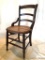 Parlor Chair: Wood parlor chair with turned spindles, and hand caned seat. Missing one seat brace,