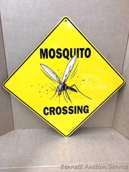 Metal sign: "Mosquito Crossing." If you live in Wisconsin, you understand how big our mosquitos are!