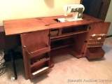Sewing Machine & Cabinet: Singer Sewing Machine with cabinet. Mechanism to hold up sewing machine